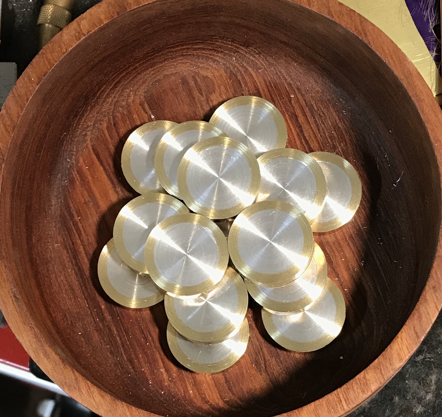 Fifteen brass/aluminum disks faced to 0.25 inches.